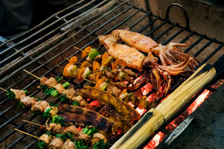 Seafood fried on the grill in a restaurant on the street. Street food in Southeast Asia. Traditional Vietnamese cuisine.の写真素材