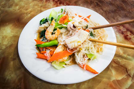 Fried noodle Thai style with shrimp, Fried Rice Sticks with Shrimp octopus and fish, Pad Thai with shrimp, Close upの写真素材