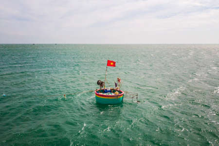 traditional, round boats on sea, with Vietnamese flag, Mui Ne Vietnamの写真素材