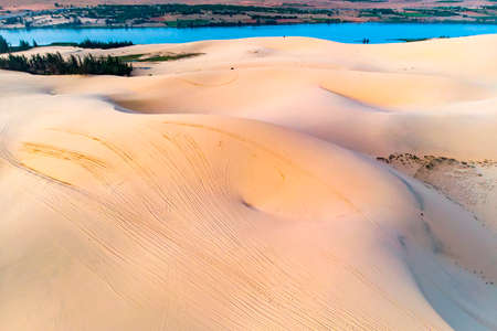sand dune in Mui Ne, Vietnam. Beautiful sandy desert landscape. Sand dunes on the background of the river. Dawn in the sand dunes of MUI ne.の写真素材
