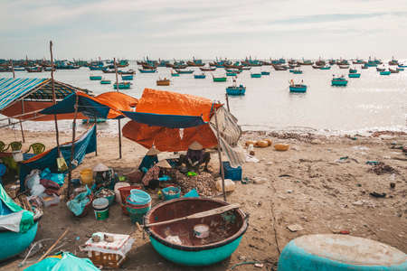 Vietnamese work in a fishing village by the sea. MUI ne. Vietnam. 27.01.2019の写真素材