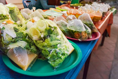 Street food at Laos, Luang Prabang. The food is packing with plastic bags ready to sell at roadside near the market.の写真素材