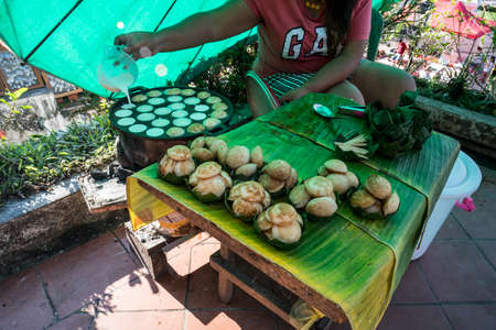 Cooking for Sweet and Savory Grilled Coconut-Rice Hotcakes it's for kanom krok but sometimes they use Coconut Rice Cake, Thai coconut pudding too. Thai Traditional Dessertの写真素材