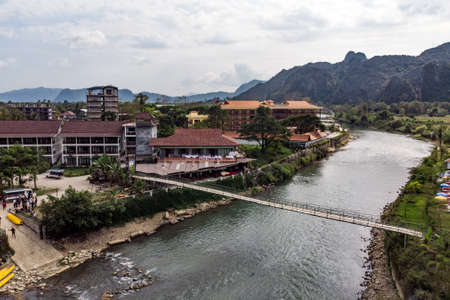 Bamboo bridge over Nam Song River at Vang Vieng village, Laos. Top view of the city. Urban landscape. Beautiful nature of Asia.の写真素材