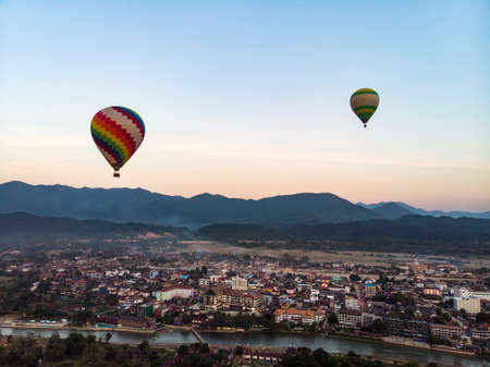 Hot air balloon over Nam Song river at sunset in Vang vieng, Laos. aerial view, top view.の写真素材