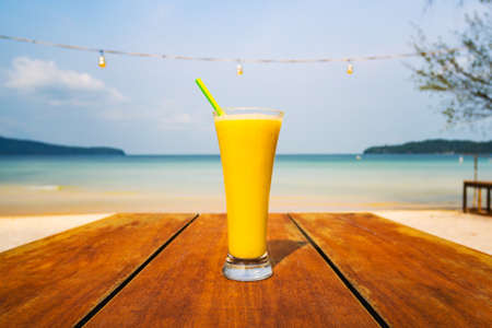 yellowcocktail on table, sea background. Vacation, vacation summer pleasure concept. Delicious fruit...