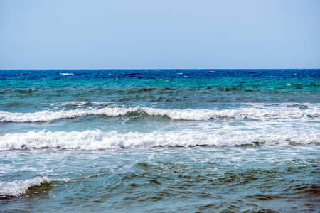 Seascape with sea horizon and almost clear deep blue sky - Background