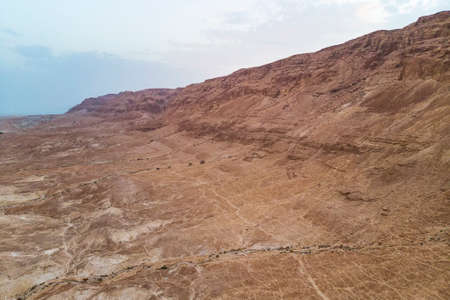 view of canyon from the top of the Masada National Park, the ruins of the palace of King Herod's Masada in the Dead Sea region of Israel. canyon cliffs against the sky. Midbar Yehudaの写真素材