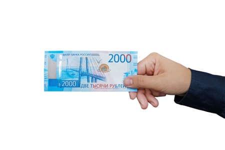 2000 rubles in male hand on white background. isolated object. Hand giving banknotes in financial, money exchange and donation concepts.の写真素材