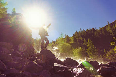 man stands over a tropic cliff stunning amazing gorgeous views high mountains waterfall greens and...