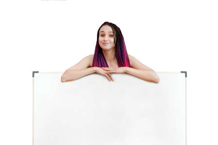 Your text here. Pretty young excited woman holding empty blank board. Portrait isolated on white background.の写真素材