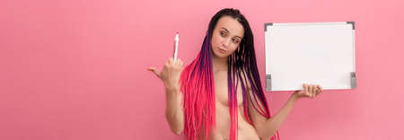 Your text here. Pretty young excited woman holding empty blank board. Sexy naked brunette holding empty board. An informal stripper teacher. nuの写真素材