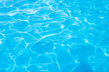 water swimming pool texture and surface water on pool. Beautiful blue water background with glare from the sun.の写真素材