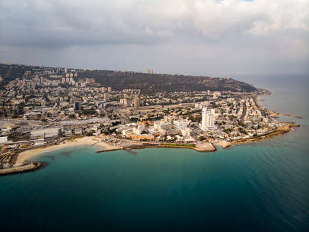 Aerial panorama of Haifa from flying drone - the third largest city of of Israel. Beautiful view of coast and seaside city on the hill. Sea shore, town, blue water and skyscape. Cityscapeの写真素材