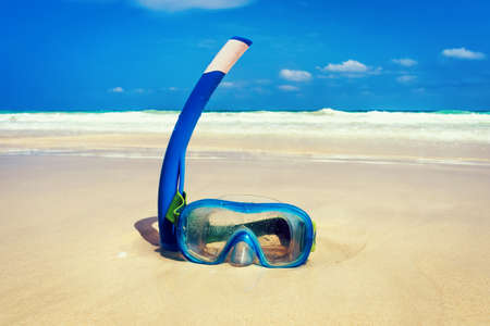The snorkel mask on the sand with the beach background.の写真素材