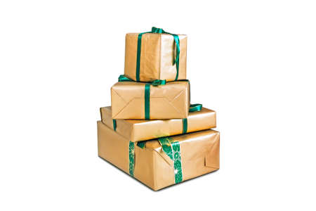 four large boxes wrapped in shiny gold gift paper. Beautiful gifts for Christmas and new year. Holiday gifts. Holiday gift boxes decorated with ribbon isolated on white background.の写真素材