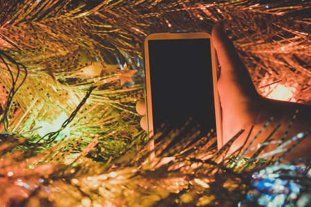 Smartphone with the empty dark screen in the childs handsの写真素材