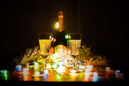 two glasses of champagne toasting againstの写真素材