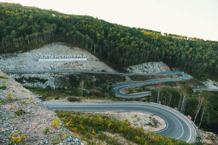 Inscription in Russian language Altai Krai is the name of a region in Western Siberia in Russia. Letters on a rock near the serpentine road. tourist cluster Belokurikha 2の写真素材