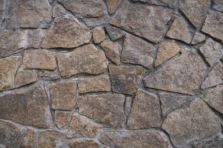 Background texture of stone wall. Fragment of wall from a chipped stoneの写真素材