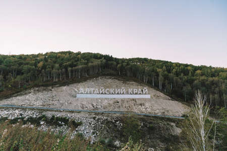 Inscription in Russian language Altai Krai is the name of a region in Western Siberia in Russia. Letters on a rock near the serpentine road. tourist cluster Belokurikha 2の写真素材