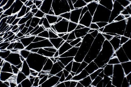 Close up of cracked glass surface. Broken glass tablet computer. Cracked screen.の写真素材