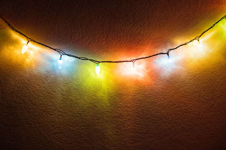 fancy christmas party lights hanging on the wallの写真素材