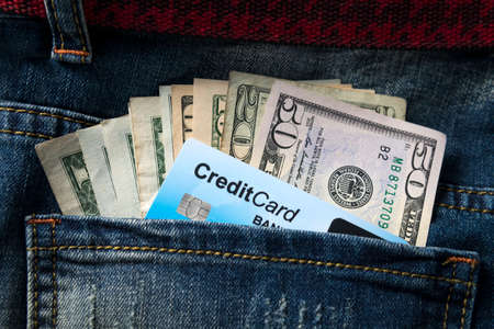American dollar banknote and credit card in a pockets of jeans close upの写真素材