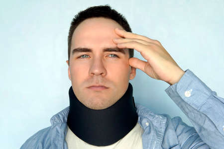 A guy with a bad neck in a black neck collar to stabilize the cervical vertebrae. A man with a neck...