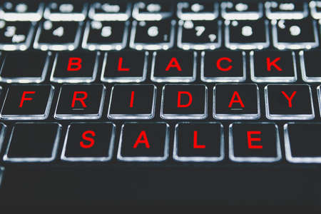 Close-up view on conceptual keyboard - Black Friday. Red letters on a black keyboard. The season of...