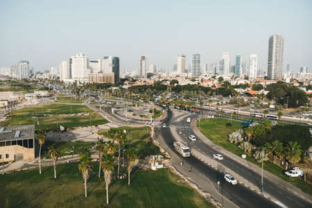 Aerial panoramic view of Tel Aviv. City buildings, well planned transport junction of highways, greenary, traffic and skysrapers in Tel Aviv. Sunny weather and the cityscape in Israeli city.の写真素材