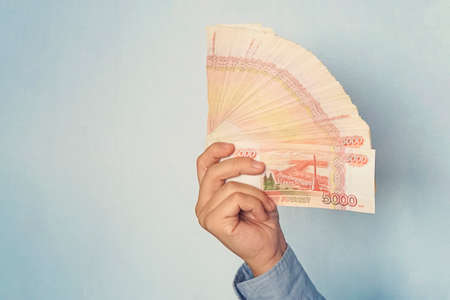five-thousandth of Russian rubles denominations in a hand. Cash in the form of a fan. copy spaceの写真素材