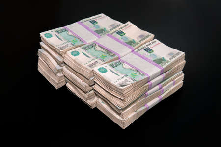 A big wad of money Russian banknotes isolated on black dark background. Million rubles in Russian rublesの写真素材