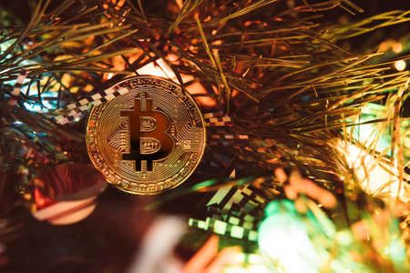 Gold bitcoin. Crypto currency bitcoin on a Christmas backgroundの写真素材