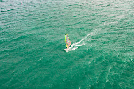 windsurfing, wind surf. Extreme sport in tropical blue ocean, clear water. Aerial views, top view of windsurf on the waves of the beautiful sea in Vietnam, MUI NEの写真素材
