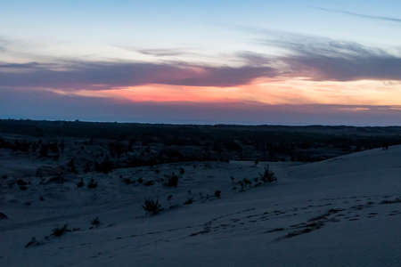 Beautiful sunrise with dramatic cloudscape at White Sand Dunes in Mui Ne, Vietnam.の写真素材