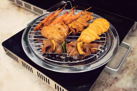 Barbecue grill In the electric stove. cooking fried food on a modern electronic grill.の写真素材