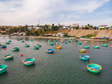 Fisherman fishing basket boats on the Vietnamese fishing village, Colourful traditional fishing boat moored Mui Ne, Vietnam. Top view. Aerial viewの写真素材
