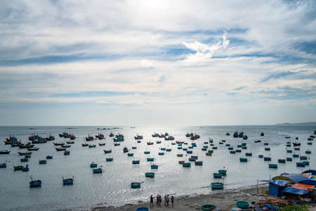 Traditional Vietnamese boat in the basket shaped on fishing port at Fishing village in sunset sky, Binh Thuan, Vietnam. Landscape. Popular landmark, famous destination of Vietnamの写真素材
