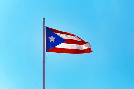 Beautiful Puerto Rican flag against a blue skyの写真素材