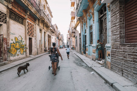 November 28, 2019, Havana, Cuba: View of authentic street with old colonial buildings and local...