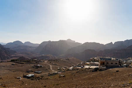 Sun is setting Distant mountains lit by the setting sun in the Wadi Rum desert reservation, Jordan.