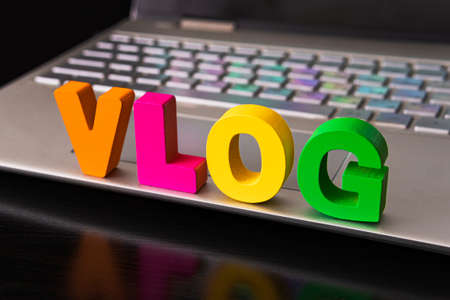 Vlog or video blog concept with vlog word from funny letters on the background computer keyboardの写真素材