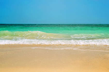 Nice wave in blue sea. Turquoise water on warm mane on blue sky background. Sea horizon lineの写真素材