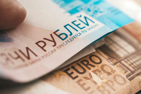 euro and rubles. The concept of currency exchange. Economic crisis, decline of the world economy. Ruble devaluation. The fall of the Russian currency. Currency exchange at the Bank.の写真素材