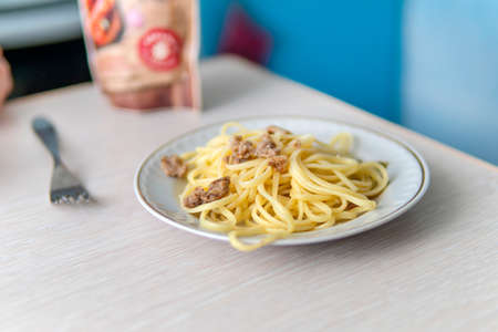 Navy macaroni on a white plate on the table in the home kitchen.の写真素材