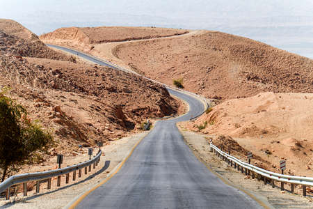empty asphalt road in middle of the desert with the nature of the middle Eastの写真素材