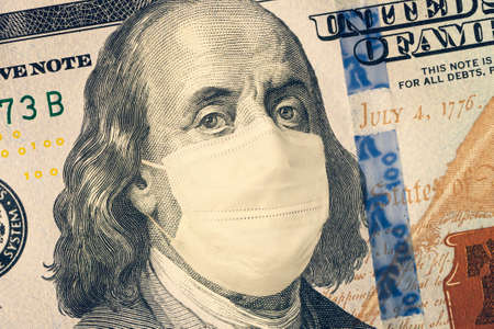 American President with a face mask against CoV infection. 100 dollar banknote. Coronavirus in United States. Concept quarantine and recession. Global economy hit by corona virus outbreak and pandemicの写真素材