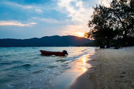 Take wate craft for rent on summer vacation tour. Rental motor boat travel in the sea at sunset. Beautiful dusk. Lazy Beach on the Koh Rong Samloem tropical islandのeditorial素材