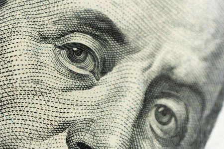 Extreme close-up of one hundred bill Franklin portrait. focus on eye